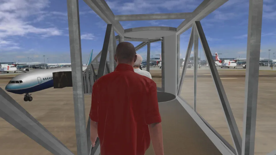 Passagier geht durch eine verglaste Fluggastbrücke