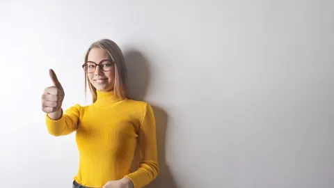 A smiling woman gives a thumbs-up