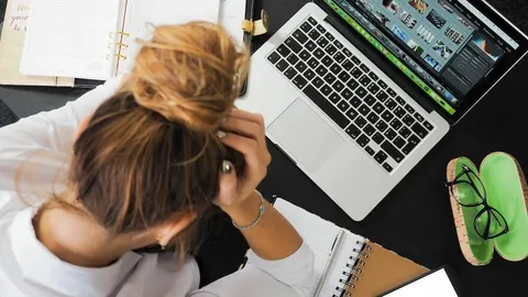 A stressed student at her desk in front of a computer