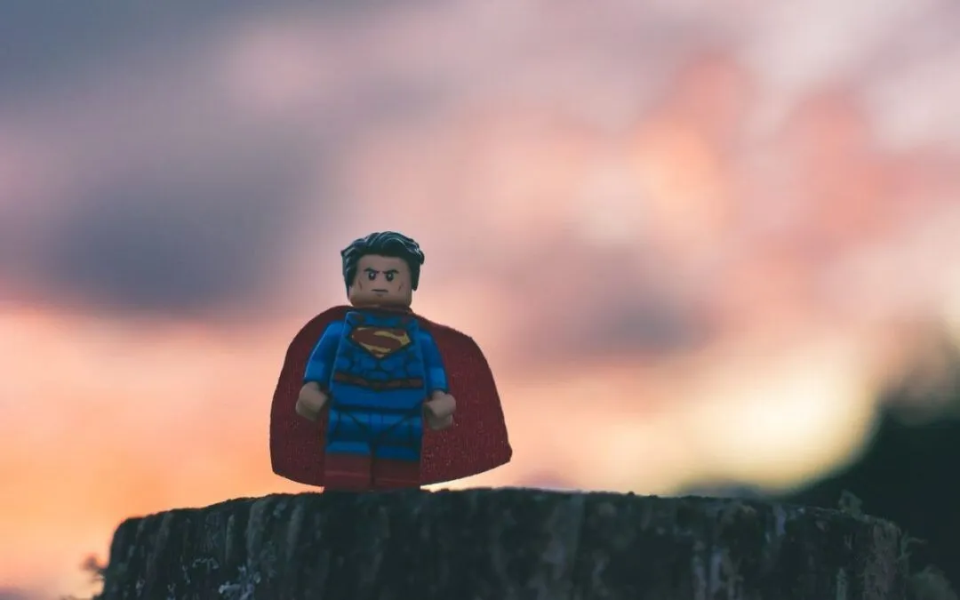 Superhero figurine standing on top of a rock